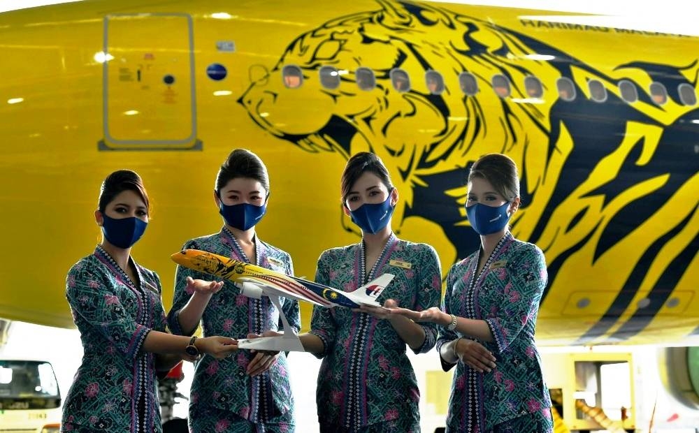 马航空姐展示老虎设计的马航空中巴士A330-300和模型，猛虎和辉煌条纹相结合的设计，吸引不少人的目光。-马新社-