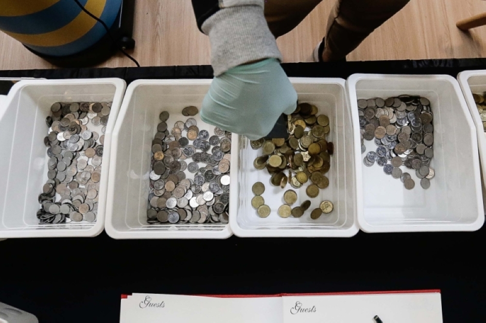 家里有太多闲置的硬币？不妨拿去给Kocek。-Sayuti Zainudin摄-