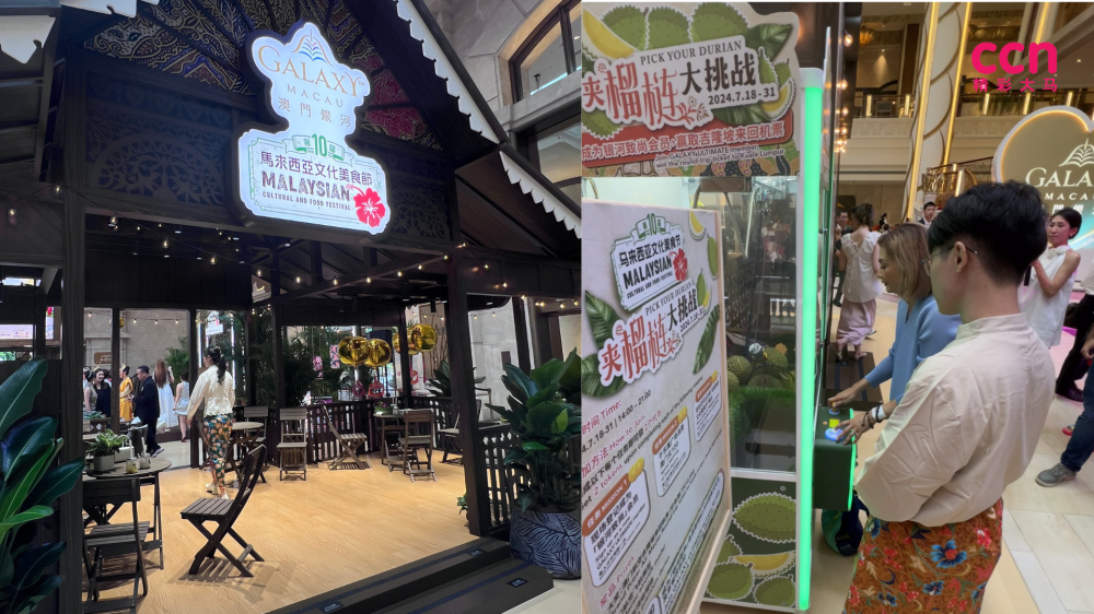 装满新鲜榴莲“娃娃机”吸引不少路过的访客跃跃欲试。-庄礼文摄-