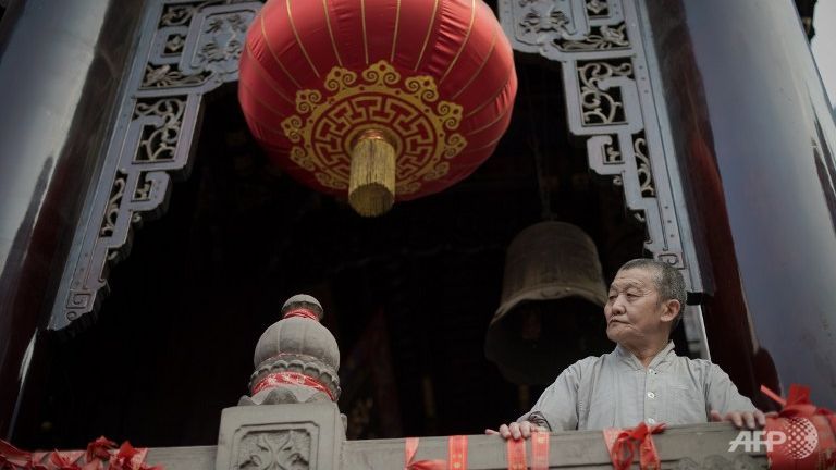 A Buddhist monk looks out from the Arhat temple in Chongqing on August 23, 2016. (Photo: AFP/Nicolas Asfouri) n