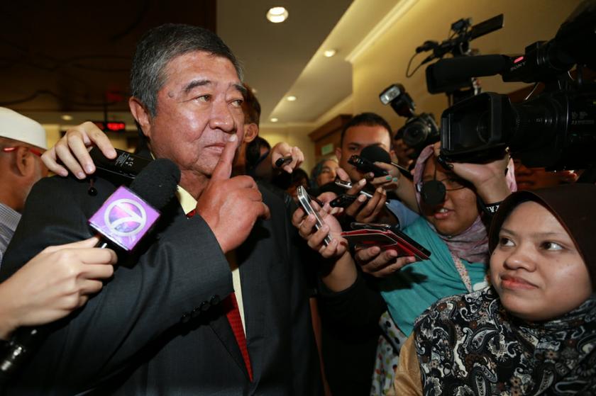 Tun Dr Ling Liong Sik, putting a finger to his lips, declined to comment after the court acquitted him from the cheating charges over the PKFZ land purchase. October 25, 2013. u00e2u20acu201d Picture by Saw Siow Feng