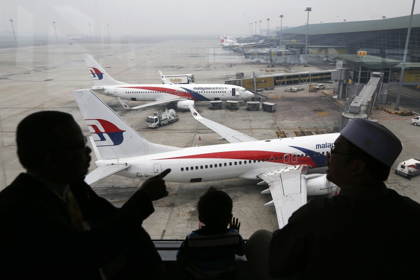 A passenger takes pictures of a Malaysia Airlines plane at the Kuala Lumpur International Airport March 16, 2014. u00e2u20acu201d Reuters pic