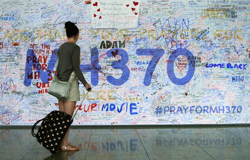 A woman looks at messages of support left for family members and passengers onboard the missing Malaysia Airlines Flight MH370 at the Kuala Lumpur International Airport (KLIA) in Sepang, outside Kuala Lumpur March 18, 2014. u00e2u20acu201d Reuters pic