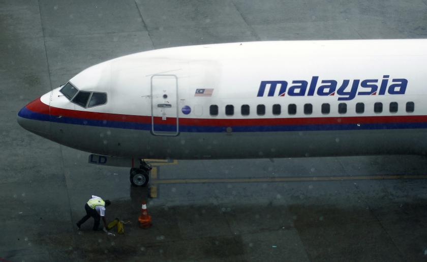 A ground staff works near a Malaysia Airlines aircraft at the Kuala Lumpur International Airport (KLIA) in Sepang, outside Kuala Lumpur March 18, 2014. u00e2u20acu201d Reuters pic