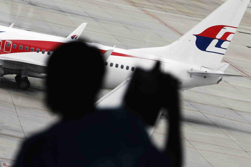 A passenger takes pictures of a Malaysia Airlines plane at the Kuala Lumpur International Airport March 16, 2014. u00e2u20acu201d Reuters pic