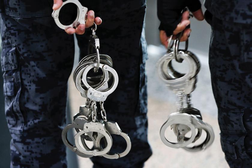 Immigration officers carry pairs of handcuffs at Kuala Lumpur International Airport March 12, 2014. u00e2u20acu201d Reuters pic