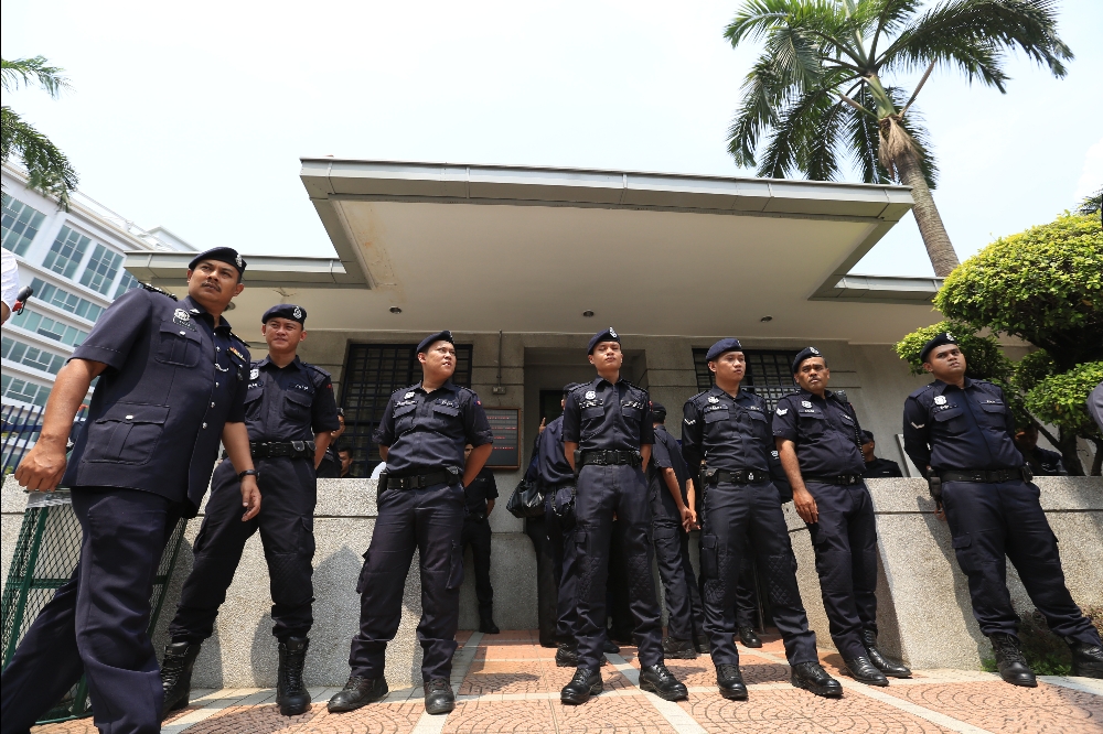 Members of the Malaysian police guarding the US Embassy in Kuala Lumpur during the protest over the MH370 media coverage by CNN and Fox News, on April 3, 2014. u00e2u20acu201d Picture by Saw Siow Feng