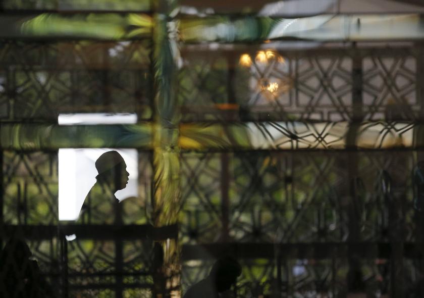 The reflection of a Muslim man is seen as he attends Friday prayers at the National Mosque in Kuala Lumpur April 11, 2014. u00e2u20acu201d Reuters pic