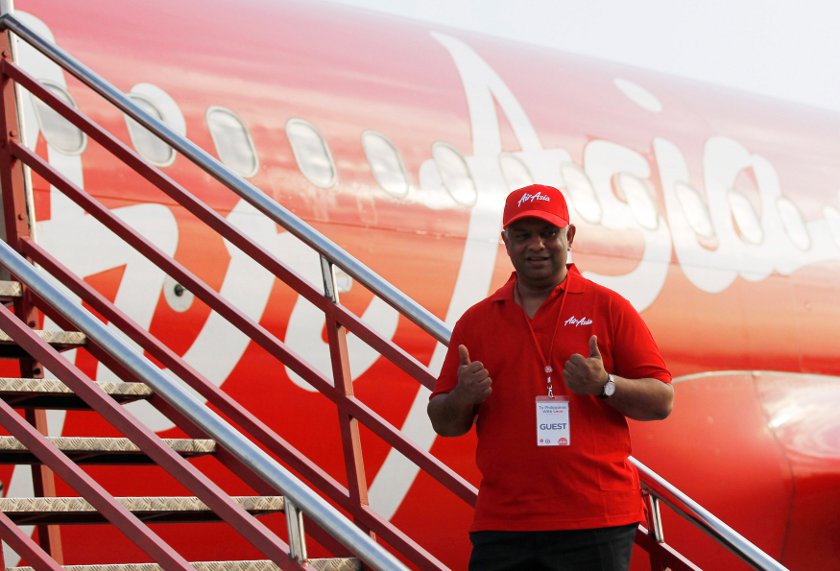 Tony Fernandes, CEO of AirAsia, gestures before boarding a AirAsia Airbus A320 plane at the domestic airport in Manila May 23, 2014. u00e2u20acu201d Reuters pic