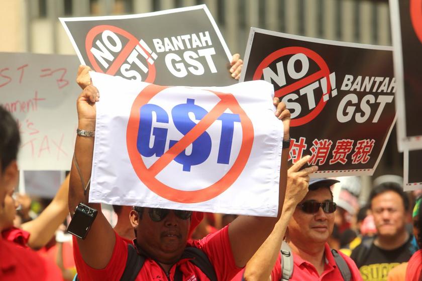 Protesters holding up placards during the protest against the Goods and Services Tax (GST) on May 1, 2014. u00e2u20acu201d Picture by Choo Choy May