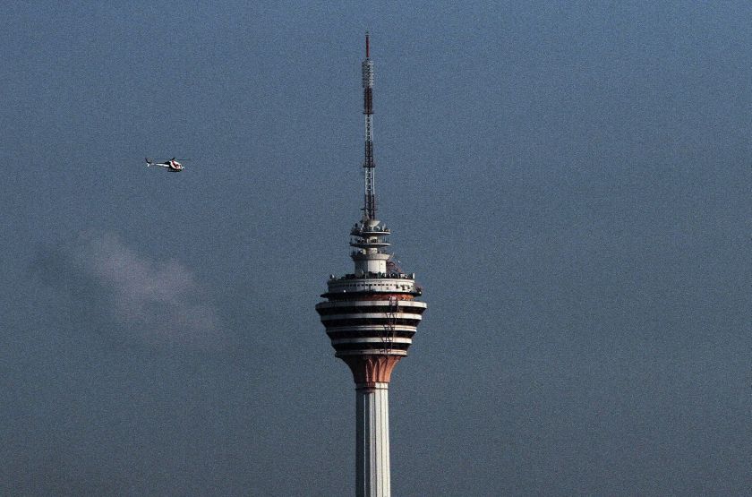 A helicopter is seen hovering over the KL Tower in Kuala Lumpur, June 18, 2014. u00e2u20acu2022 Picture by Yusof Mat Isa