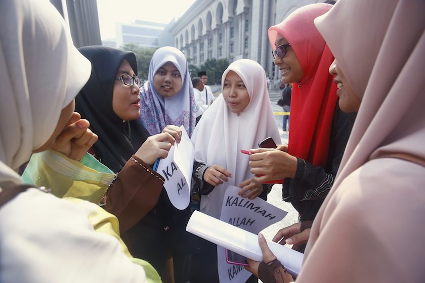 Muslim women gather outside the court after a hearing on the u00e2u20acu02dcAllahu00e2u20acu2122 court case in Putrajaya outside Kuala Lumpur June 23, 2014. u00e2u20acu201d Reuters pic