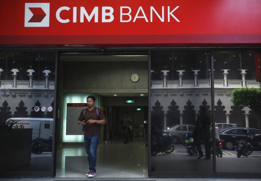 A man walks out of a CIMB Bank in Kuala Lumpur July 10, 2014. u00e2u20acu201d Reuters pic