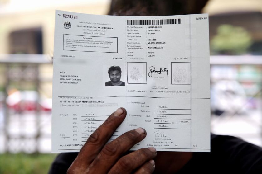 A homeless person showing off the temporary document for MyKad, July 20, 2014. u00e2u20acu201d Picture by Choo Choy May