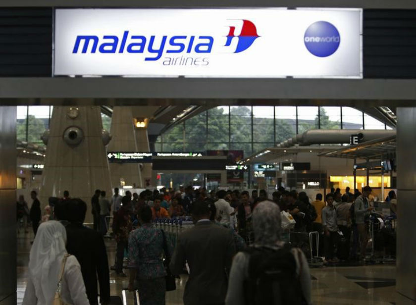 Passengers queue up at the Malaysia Airlines ticketing booth at the Kuala Lumpur International Airport in Sepang March 9, 2014. u00e2u20acu201d Reuters pic