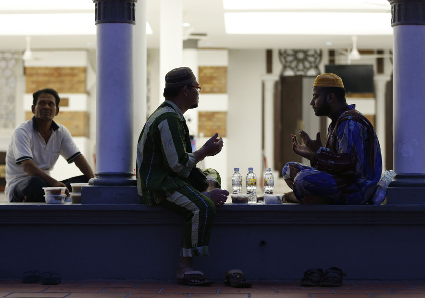 Men pray before breaking their fast on the last day of Ramadan at Masjid Jamek (Jamek Mosque) in Kuala Lumpur July 27, 2014. u00e2u20acu201d Reuters pic
