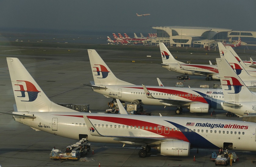 Ground crew work among Malaysia Airlines planes on the runway at Kuala Lumpur International Airport (KLIA) in Sepang July 25, 2014. u00e2u20acu201d Reuters pic 