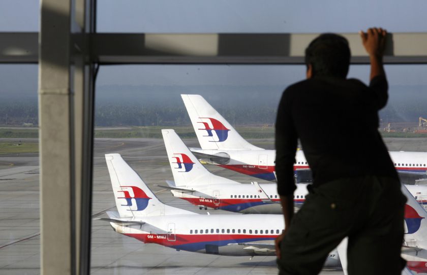 A traveller stands at the viewing gallery overlooking Malaysian Airline System &#40;MAS&#41; aircrafts at Kuala Lumpur International Airport in Sepang outside Kuala Lumpur in this December 23, 2009 file photo. u00e2u20acu201d Reuters pic