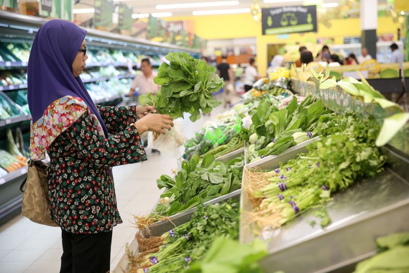 A shopper chooses fresh vegetables from the fresh produce section in Tesco. u00e2u20acu201d Picture by Choo Choy May