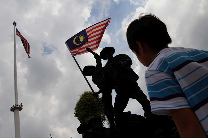 A boy looks at a replica of Tugu Negara at Dataran Merdeka. Malaysia will celebrate its 57th year of independence on August 31, 2014. u00e2u20acu201d Picture by Yusof Mat Isa