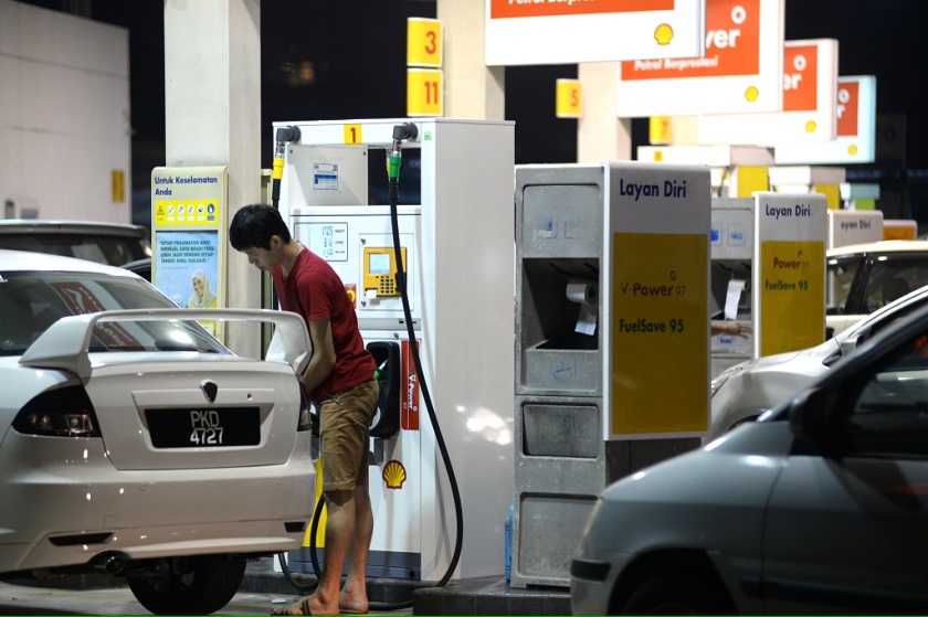 A motorist fills up his car with petrol before the 20 sen petrol price increase at midnight, George Town, October 1, 2014. u00e2u20acu201d Picture by K.E. Ooi