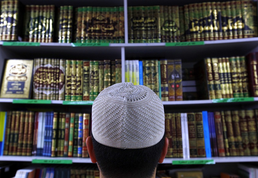 A man wearing an Islamic prayer cap, or Kufi, looks at Islamic books on display at a bookshop located in the western Sydney suburb of Lakemba, October 3, 2014. u00e2u20acu201d Reuters pic