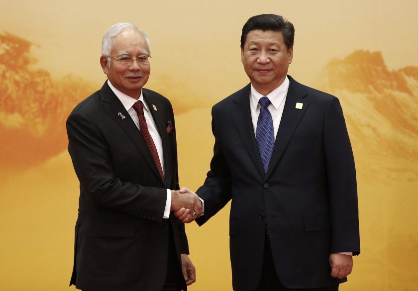 Malaysia's Prime Minister Najib Razak (left) shakes hands with China's President Xi Jinping during a welcoming ceremony of the Asia Pacific Economic Cooperation (APEC) forum in Beijing, November 11, 2014. u00e2u20acu201d Reuters pic