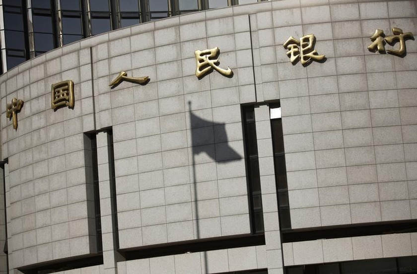 A fluttering Chinese national flag casts its shadow on the People's Bank of China in Beijing November 24, 2014.   u00e2u20acu201d Reuters pic