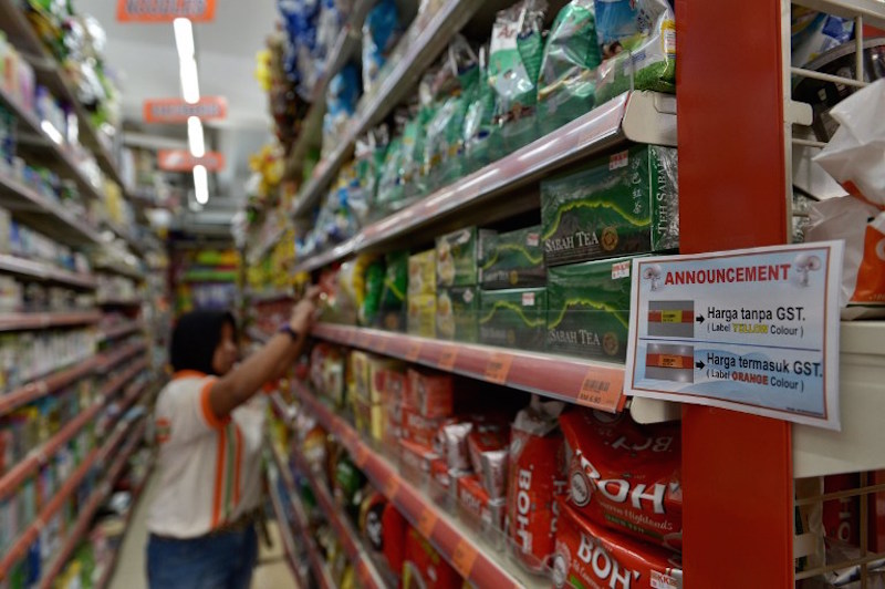 A notice announcing the GST is displayed on the shelves of a supermarket in Kuala Lumpur April 1, 2015. u00e2u20acu201d AFP pic