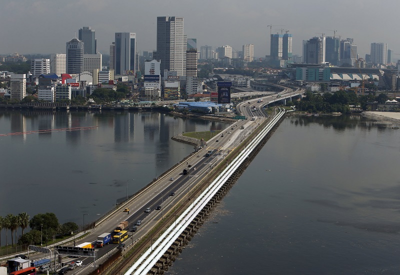 Vehicles travel along the causeway between Singapore and Malaysia (top) at the Woodlands Checkpoint in Singapore, May 5, 2015. u00e2u20acu201d Reuters pic