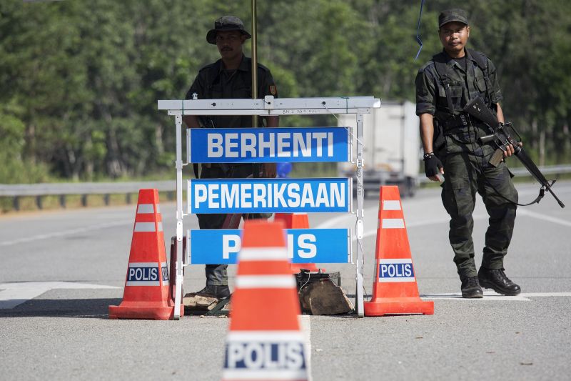 Members of the General Operations Force control the checkpoint near the area where the abandoned human trafficking camp was discovered close to the Thailand border at Bukit Wang Burma in northern Malaysia May 28, 2015. u00e2u20acu2022 Reuters pic