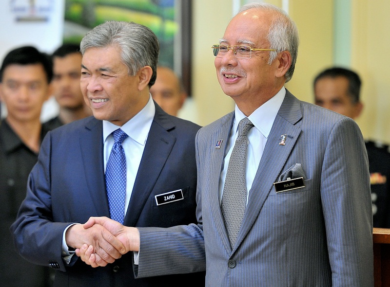 Prime Minister Datuk Seri Najib Razak shakes hands with his new deputy, Datuk Seri Zahid Hamidi, at the Prime Minister Office in Putrajaya, July 28, 2015. u00e2u20acu201du00c2u00a0Bernama pic