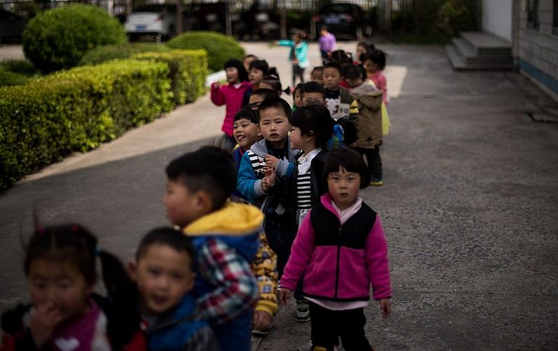 This photo taken on April 17, 2015 shows children playing in the schoolyard of the once-bustling Technical Secondary School in Rudong, Jiangsu province. u00e2u20acu2022 AFP pic