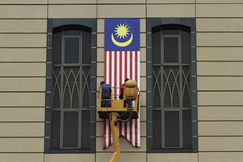 Workers are seen hanging up the national flag outside the Ministry of Finance building in Putrajaya, August 19, 2015, ahead of National Day celebrations. u00e2u20acu201d Picture by Yusof Mat Isa