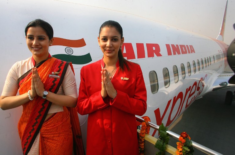 Air India air hostesses, wear their new uniform atop the Air India flight, during the delivery of the Boeing 737-800 Commercial Jetliner for Air India in New Delhi November 6, 2006. u00e2u20acu201d AFP pic