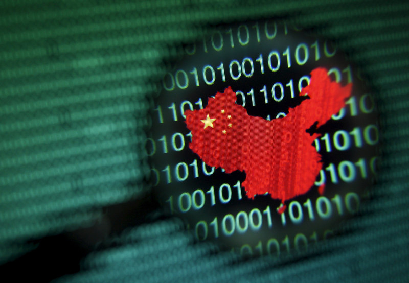 A graphic shaped in the outline of China, is seen through a magnifying glass on a computer screen showing binary digits in Singapore in this file photo illustration. u00e2u20acu201d Reuters pic