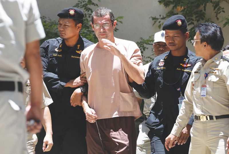 Thai police escort Justo out of a South Bangkok criminal court complex last month. He told Thai authorities he was not involved in any political conspiracy. u00e2u20acu2022 Malay Mail pic