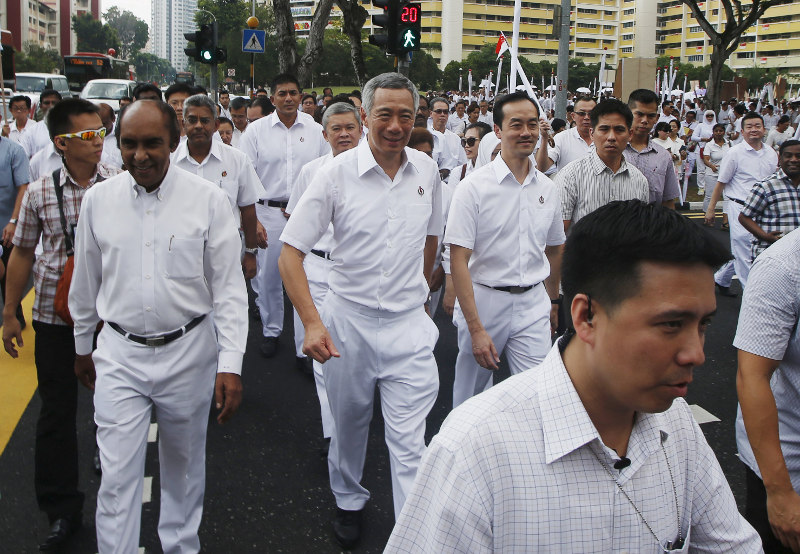 Singaporeu00e2u20acu2122s Peopleu00e2u20acu2122s Action Party (PAP) secretary-general Lee Hsien Loong crosses a street with his supporters to submit his papers during nomination day, ahead of the general elections in Singapore September 1, 2015. u00e2u20acu201d Reuters pic