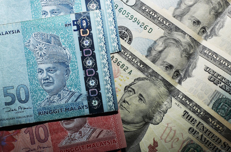 Malaysian ringgit notes are seen among US dollar bills in this photo illustration taken in Singapore in this August 24, 2015 file photo. u00e2u20acu201d Reuters pic 