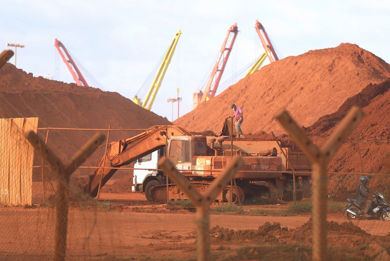 An excavator fills a lorry with bauxite at the stockpile area at Kuantan port. u00e2u20acu201d Picture by Ahmad Zamzahuri