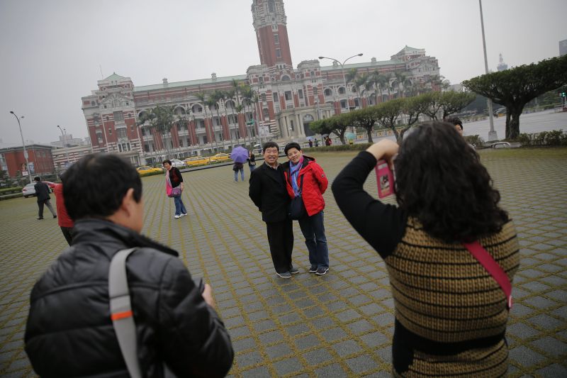 Tourists take pictures of themselves in front of the presidential palace in Taipei, Taiwan. u00e2u20acu2022 Reuters pic