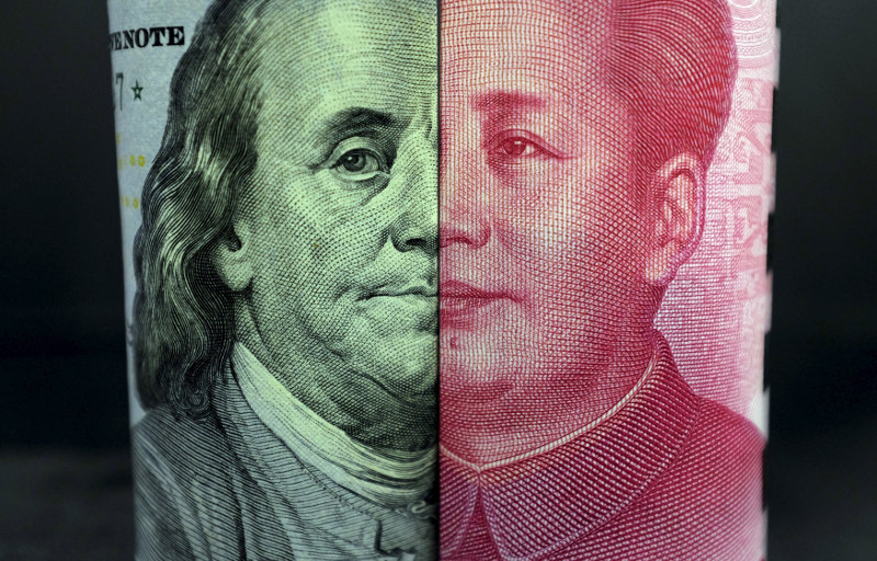 A US 100-dollar banknote with a portrait of Benjamin Franklin and a Chinese 100-yuan banknote with a portrait of late Chinese Chairman Mao Zedong are seen in the picture illustration in Beijing, China, January 21, 2016. u00e2u20acu201d Reuters pic