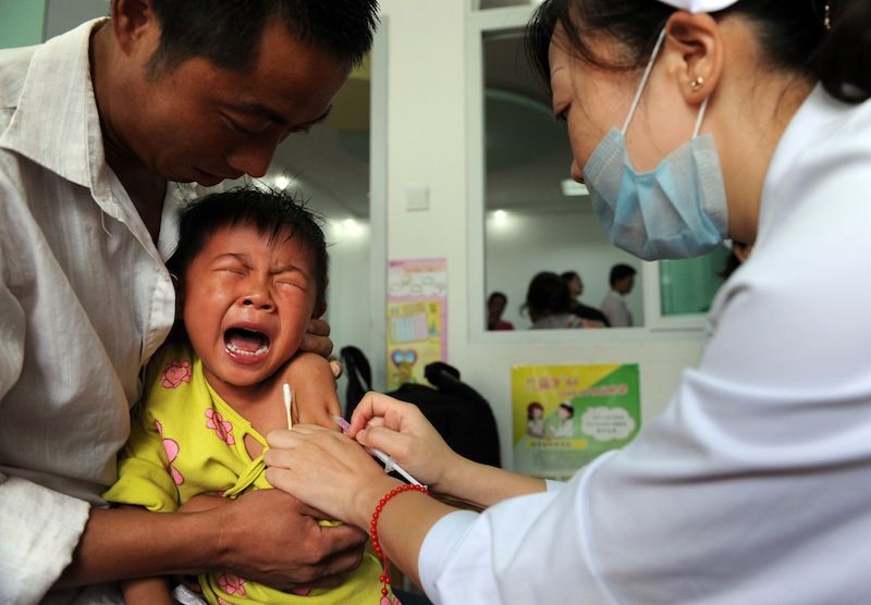 A Chinese boy screams out in pain as he gets inoculated against measles as part of a free 10-day nationwide campaign in Hefei, in eastern China's Anhui province on September 11, 2010. u00e2u20acu201d AFP pic
