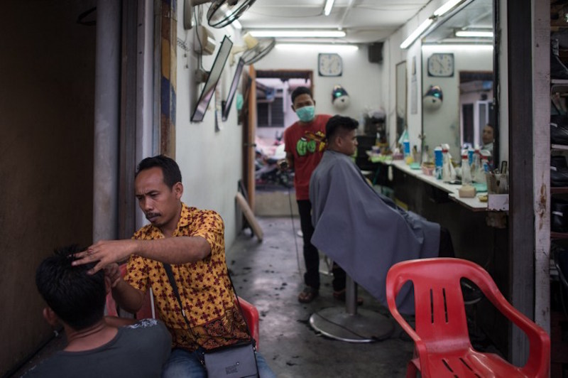 Barbers work at a shop in Kampung Baru, Kuala Lumpur, March 22, 2016. u00e2u20acu201d AFP picn