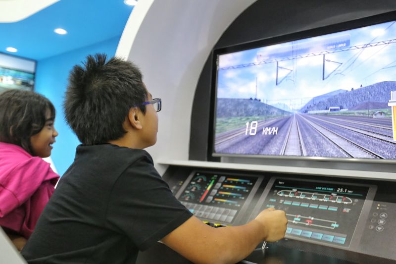 A child plays the role of a train captain in KL-Singapore HSR project exhibition at NU Sentral, Kuala Lumpur, June 15, 2016. u00e2u20acu2022 Picture by Saw Siow Feng