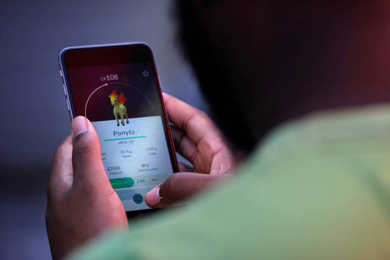 Theodore Belizaire plays the augmented reality mobile game u00e2u20acu02dcPokemon Gou00e2u20acu2122 by Nintendo in Times Square, New York, July 11, 2016. u00e2u20acu201d Reuters pic