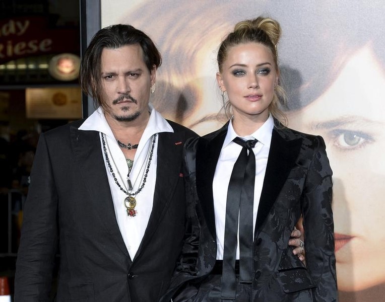 Cast member Amber Heard and husband Johnny Depp pose during the premiere of the film ,The Danish Girl,, in Los Angeles, California November 21, 2015. REUTERS/Kevork Djansezian/File Photo