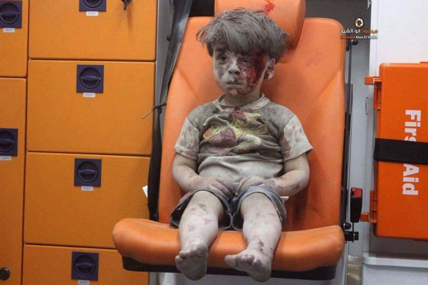 A still image taken on August 18, 2016 from a video posted on social media said to be shot in Aleppo on August 17, 2016, shows a boy with bloodied face sitting in an ambulance, after an airstrike, Syria. u00e2u20acu201d Handout via Reuters