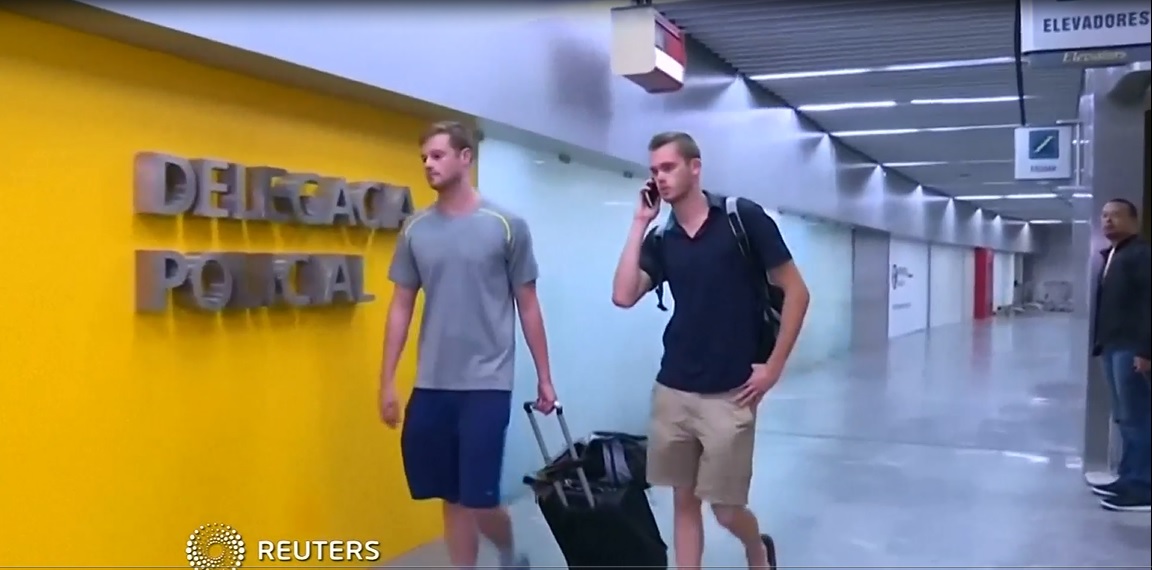 US swimmers Jack Conger (left) and Gunnar Bentz walk into a police office of Rio de Janeirou00e2u20acu2122s international airport after they were stopped from boarding a flight to the United States following their participation in the Rio 2016 Olympic Games, August 1