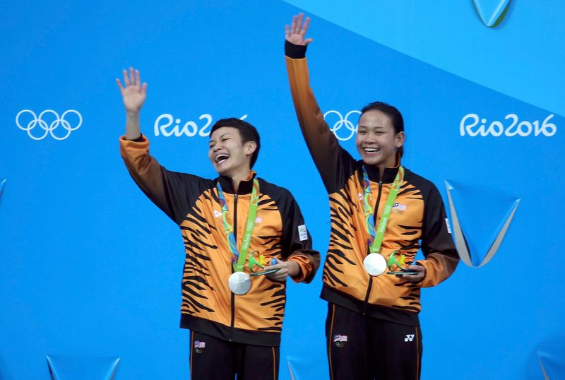 Cheong Jun Hoong and Pandelela Rinong of Malaysia celebrate with their silver medals on the podium at the Maria Lenk Aquatics Centre, Rio de Janeiro August 10, 2016. u00e2u20acu201d AFP pic